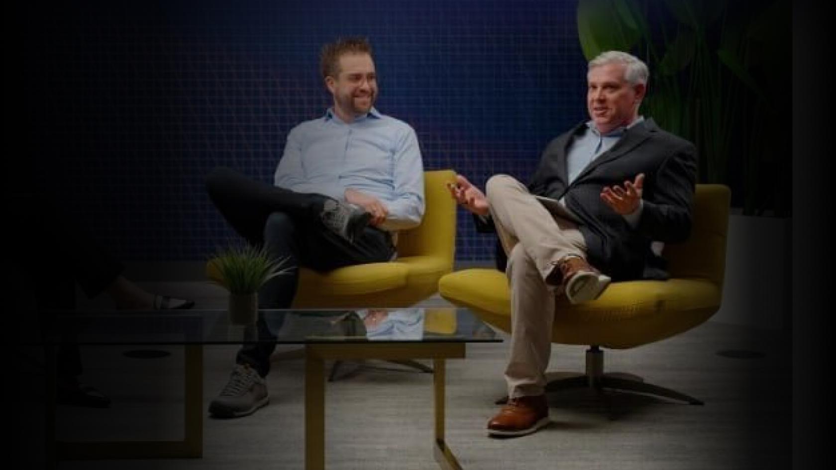 Two male panelists seated together discussing the future of healthcare