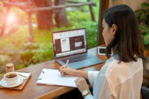 woman at laptop writing