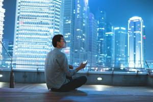 man sitting on roof at night