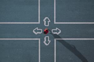 Overhead view of person at a crossroad choosing between four directions