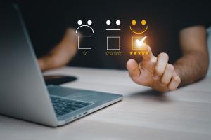 person at computer giving five star rating