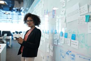 woman standing in front of whiteboard 
