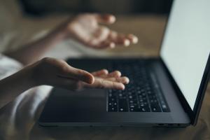 Two hands over laptop 