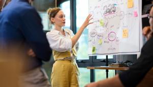 Woman gesturing at whiteboard