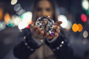 Color photo of woman holding crystal ball