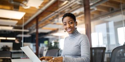 Woman sitting in conference room with laptop