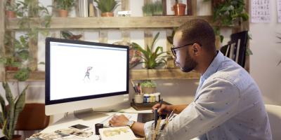 Person at desk working on computer in office