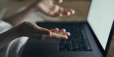 Two hands over laptop 