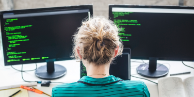 Man on a computer with two screens