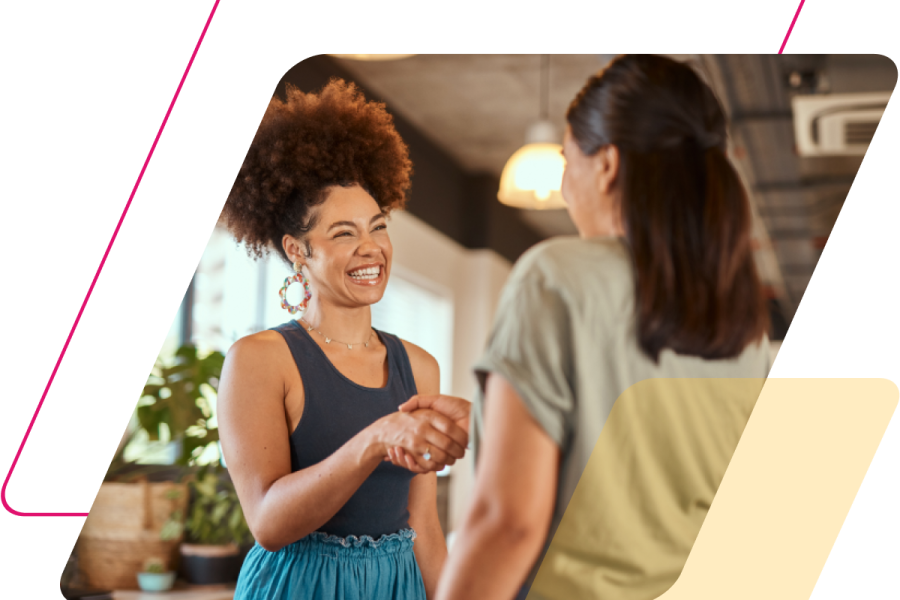 pink and yellow parallelograms with an image of two women shaking hands