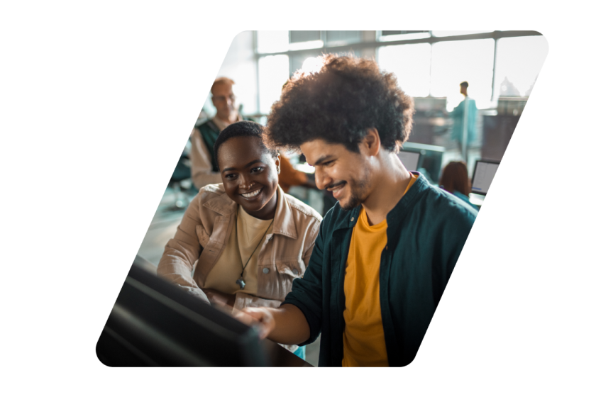 Two people smiling at a computer