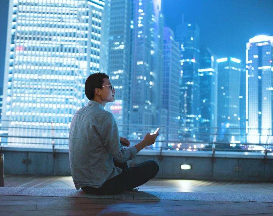man sitting on roof at night