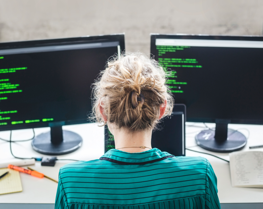 Man on a computer with two screens