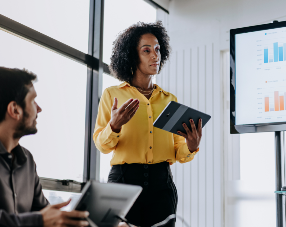Woman standing with tablet, giving presentation