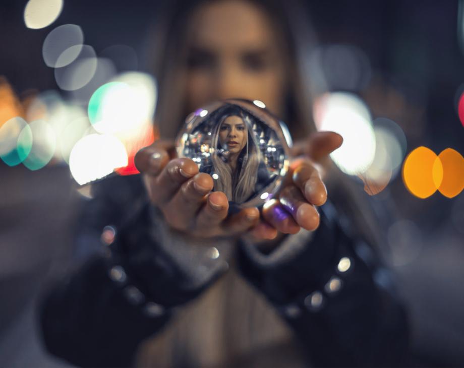 Color photo of woman holding crystal ball