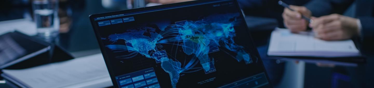 Laptop on table with world map