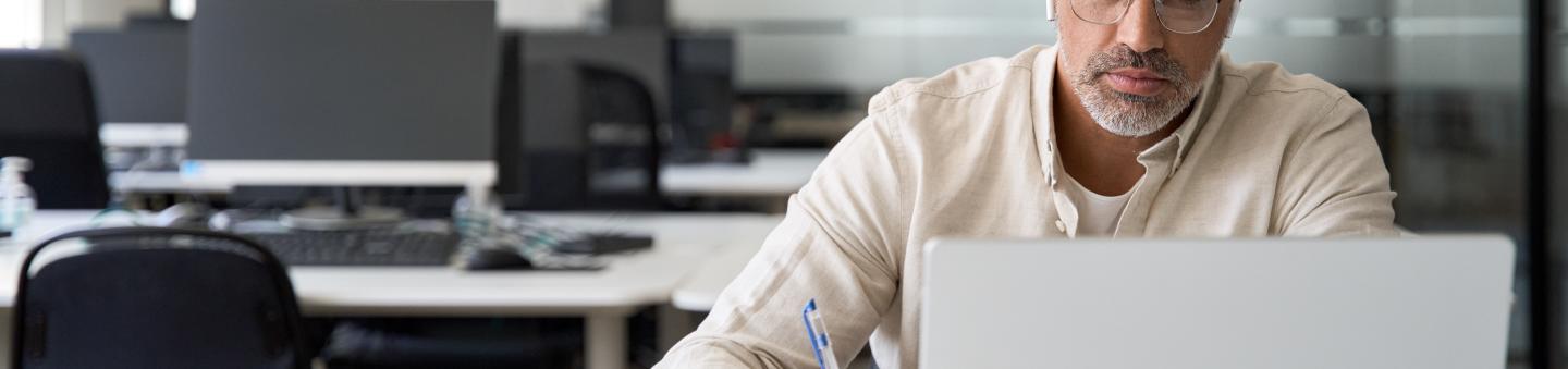 Person working on laptop in open office