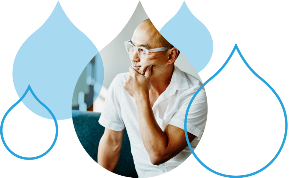 person with glasses surrounded by acquia droplets